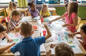 kids doing crafts around a table.